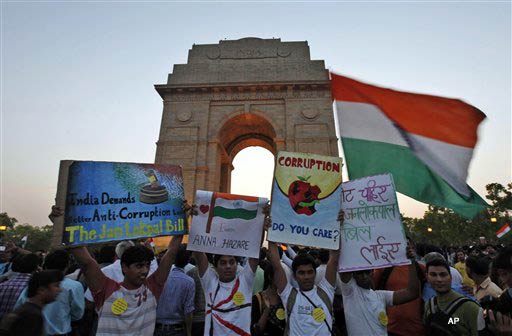 Anti corruption supporters celebrate at the India Gate war memorial in New Delhi, India, Saturday, April 9, 2011. India's government ordered up strong anti corruption legislation on Saturday after a 73 year old activist went on a four day hunger strike and inspired a nationwide protest movement against graft. Anna Hazare, whose hunger strike drew wide attention and support from politicians and Bollywood stars, ended his fast Saturday by accepting lime water from a child, but warned he'd resume it if anti corruption laws are not improved by Aug. 15. (AP Photo/Mustafa Quraishi)