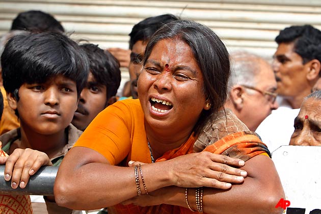 A devotee reacts in grief as an ambulance, not seen, carrying the body of the Hindu holy man Sathya Sai Baba reaches at his ashram for public viewing in Puttaparti, about 450 kilometers (280 miles) from Hyderabad, India, Sunday, April 24, 2011. Baba, considered a living god by millions of followers worldwide, died Sunday in a hospital near his southern Indian ashram, a doctor said. He was 86. (AP Photo/Aijaz Rahi)