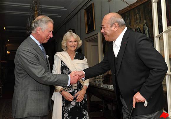 Britain's Prince Charles shakes hands with His Majesty King George Tupou V of Tonga, as he and the Duchess of Cornwall welcome him to their home at Clarence House in central London, Thursday April 28, 2011.(AP Photo/John Stillwell pa)