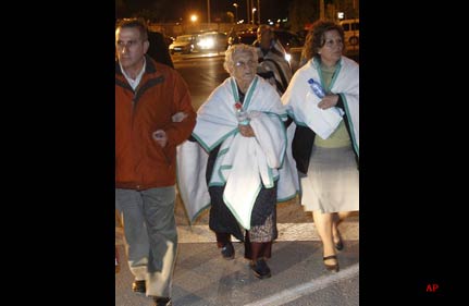Two women walk with blankets as people spend the night outside their homes following Wednesday's two earthquakes, in Lorca, Spain, in the early hours of Thursday, May 12, 2011. The epicenter of the quakes, with magnitudes of 4.4 and 5.2, was close to the town of Lorca, and the second came about two hours after the first, an official with the Murcia regional government said on condition of anonymity in line with department policy. Dozens of injured people were being treated at the scene and a field hospital was set up in the town of about 85,000 people, officials said. (AP Photo/Alberto Saiz)
