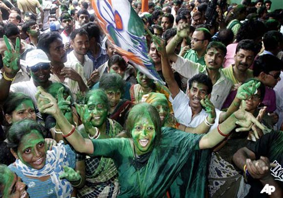 Trinamool Congress party supporters paint their faces with colored powder as they celebrate the early leads outside the residence of party leader Mamata Banerjee in Kolkata, India, Friday, May 13, 2011. Counting of votes began Friday in India's fourth most populous state of West Bengal, where India's ruling Congress and its ally Trinamool Congress were predicted to unseat a Communist led government that has held power for 34 years. (AP Photo/Rajesh Kumar Singh)