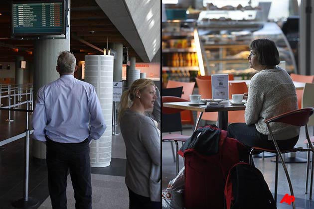 A man (left) and a woman (right) watches a flight information board at Keflavik airport, Keflavik, Iceland Sunday May 22, 2011 as Iceland closed its main international airport and canceled domestic flights as a powerful volcanic eruption sent a plume of ash, smoke and steam 12 miles (20 kilometers) into the air. The eruption was far larger than one a year ago that caused international travel chaos but scientists said it was unlikely to have the same widespread effect. (AP Photo/Brynjar Gauti)