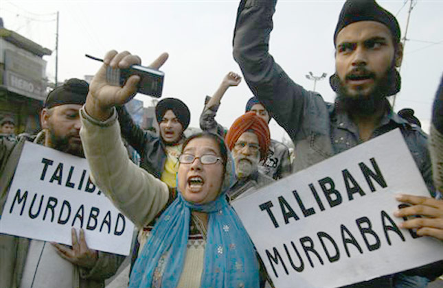 Sikh protesters shout slogans against Taliban and Pakistani goverment during a strike in Jammu, India, Tuesday, Feb. 23, 2010. The protest took place after the decapitated bodies of two Sikhs were found almost a month after they were kidnapped in Pakistan's Khyber tribal region. The placards held by the protesters read Death to Taliban. (AP Photo/Channi Anand)