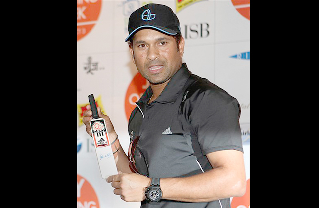 Indian cricketer Sachin Tendulkar holds a bat during an event in Mumbai, India, Tuesday, March 2, 2010. Tendulkar recently scored the first ever double century in one day international cricket, in a match against South Africa. (AP Photo/Rafiq Maqbool)