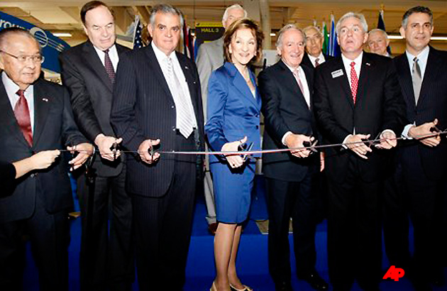 The President of the Aerospace Industries Association Marion Blakey, center, with US Secretary of Transportation Ray Lahood, third from left, attend the ribbon cutting ceremony of the US pavillion, on the first day of the Paris air show, at the Bourget airport, Monday June 20, 2011. Others in the photo from left, Hawaii senator Daniel Inouye, Alabama senator Richard Shelby, two unidentified, Under Secretary of International Trade Francisco J Sanchez, and Secretary of the Air Force Michael Donley. (AP Photo/Remy de la Mauviniere)