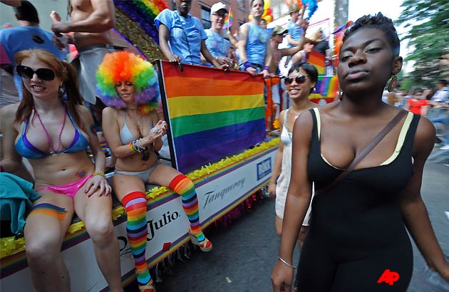 The annual Gay Pride parade works its way through Christopher Street in Greenwich Village, Sunday, June 26, 2011, in New York. One of the world's oldest and largest gay pride parades was expected to become a victory celebration Sunday after New York's historic decision to legalize same sex marriage. The law signed by Gov. Andrew Cuomo on Friday doesn't take effect for 30 days. (AP Photo/Louis Lanzano)