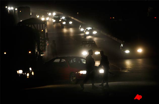 Afghan police officers stop vehicles entering the road leading to the Inter Continental hotel, which is under attack in Kabul, Afghanistan, Tuesday, June 28, 2011. Four suicide bombers and at least two gunmen attacked a Western style hotel in Kabul late Tuesday night and police who rushed to the scene fought the assailants with machine guns and rocket propelled grenades, Afghan officials said. Afghan Interior Ministry spokesman Sediq Sediqqi said all the bombers either blew themselves up or were killed while two gunmen continued to fire from the roof. (AP Photo/Gemunu Amarasinghe)