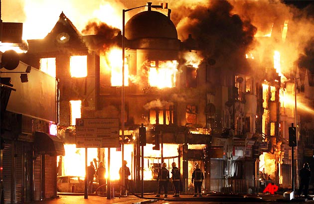 A property is on fire near Reeves Corner in Croydon, south London Tuesday, Aug. 9, 2011. A wave of violence and looting raged across London and spread to three other major British cities on Tuesday, as authorities struggled to contain the country's worst unrest since race riots set the capital ablaze in the 1980s. (AP Photo/PA, Lewis Whyld)