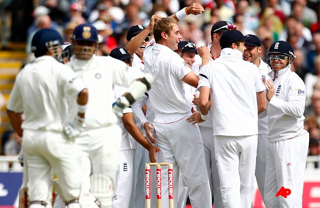 England's Stuart Broad, center, is congratulated by teammates after taking the wicket of India's Virender Sehwag, second left, on the first day of the third test match at the Edgbaston Cricket Ground, Birmingham, England, Wednesday, Aug. 10, 2011. (AP Photo/Tim Hales)