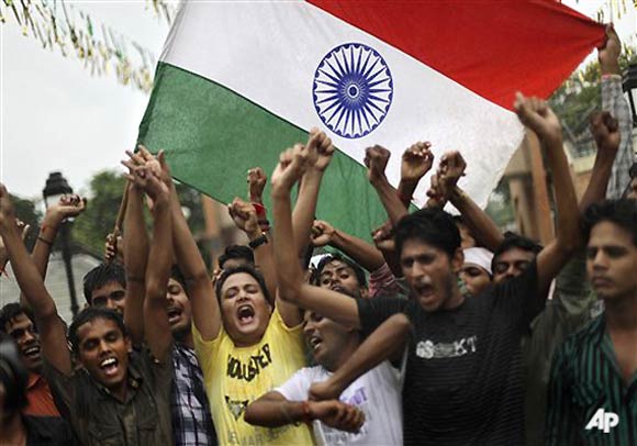 Indian youths shout slogans as they celebrate Independence Day at the Indo Pak joint check post of Wagah, India, Monday, Aug. 15, 2011. India marked 64 years of independence from British rule. (AP Photo/Altaf Qadri)