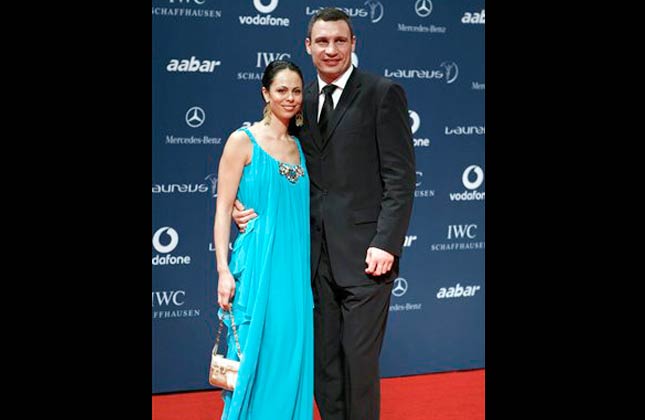 Ukrainian professional heavyweight boxer and the current WBC world heavyweight champion, Vitali Klitschko, right, arrives with his wife for the Laureus Awards in Abu Dhabi, United Arab Emirates Wednesday March 10, 2010.(AP Photo/Farhad Berahman)