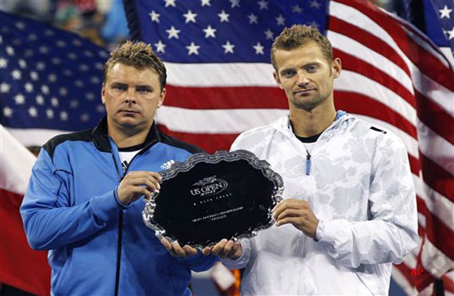 The doubles team of Marcin Matkowski, left, and Mariusz Fyrstenberg, both of Poland, pose with the runner up trophy after losing 6 2, 6 2 to Jurgen Melzer, of Austria, and Philipp Petzschner, of Germany, in the mens doubles final at the U.S. Open tennis tournament in New York, Sunday, Sept. 11, 2011. (AP Photo/Elise Amendola)