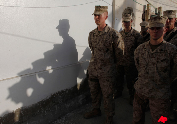 U.S. Marines stand in formation to observe a moment of silence held at the time of the Sept. 11, 2001 attacks against the U.S., in memory of the victims, at Forward Operating Base Jackson, in Sangin, Helmand province, Afghanistan, Sunday, Sept. 11, 2011. Ten years have passed since the deadly 9/11 attacks that led the United States to wage war in Afghanistan. (AP Photo/Brennan Linsley)