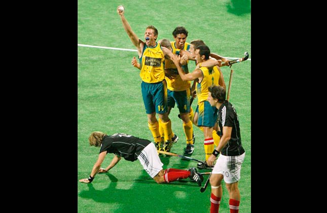 Australia's Grant Schubert, top left, holds up the game ball after winning the gold medal match against Germany during the International Hockey Federation (FIH) World Cup 2010 field hockey in New Delhi, India, Saturday, March 13, 2010. Australia defeated Germany 2 1 Saturday to win the men's field hockey World Cup. (AP Photo/Saurabh Das)