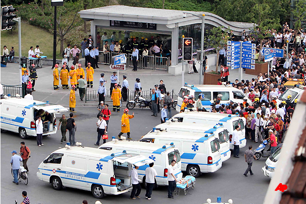 Ambulances wait outside a station of the Subway Line 10 after subway collision in Shanghai, east China, Tuesday, Sept. 27, 2011. A subway train in China's commercial center of Shanghai has smashed into the back of another train, injuring dozens of people. (AP Photo/Xinhua, Fan Jun)