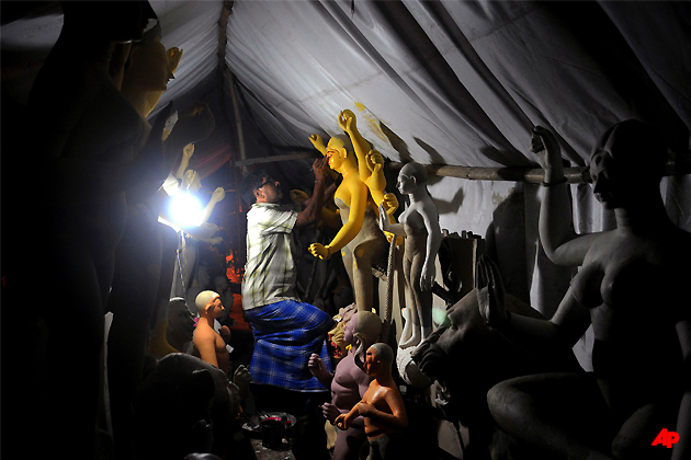 An artisan prepares an idol of Hindu Goddess Durga, ahead of Durga Puja festival in Agartala, India, Tuesday, Sept. 20, 2011. The five day festival, which begins Oct. 2, commemorates the slaying of a demon king by lion riding, 10 armed goddess Durga, marking the triumph of good over evil. (AP Photo/Sushanta Das)