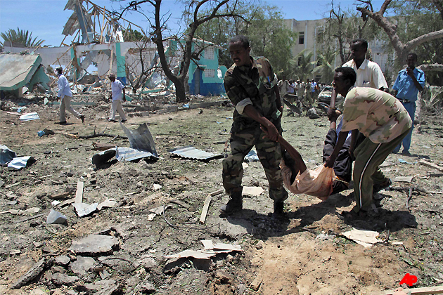 Somalis carry a wounded man at the scene of an explosion in Mogadishu, Somalia, Tuesday, Oct. 4, 2011. A rescue official says at least 55 people were killed after a car laden with explosives blew up in front of the Ministry of Education in the Somali capital of Mogadishu. The al Qaida linked militant group al Shabab immediately claimed responsibility for the attack on a website it uses, after more than a month of relative calm in Mogadishu.(AP Photo/Mohamed Sheikh Nor)