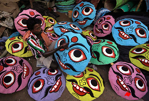 In this Wednesday, Oct. 5, 2011 photo, an Indian artist paints masks of demon king Ravana to be used in Dussehra festivities in Bhubaneshwar, India. Dussehra festival commemorates the victory of Rama over Ravana, an evil ruler who had abducted Rama's wife, Sita. The festival culminates on Oct. 6 with the burning of effigies of Ravana, signifying the victory of good over evil. (AP Photo/Biswaranjan Rout)