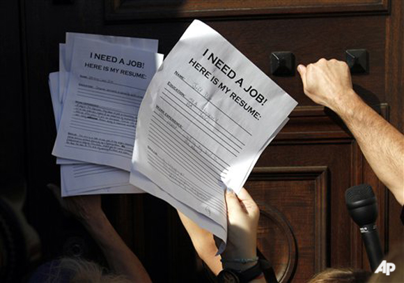 FILE In this Oct. 6, 2011 file photo, protesters knock on the door of the Chamber of Commerce with resumes during a protest in Washington. Having started in New York, the demonstrations now take place all across the United States, as protesters are speaking out against corporate greed and the gap between the rich and the poor. (AP Photo/Jacquelyn Martin, File)