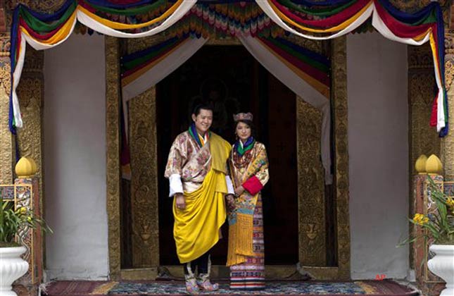 King Jigme Khesar Namgyal Wangchuck, left, and Queen Jetsun Pema pose after they were married at the Punakha Dzong in Punakha, Bhutan, Thursday, Oct. 13, 2011. The 31 year old reformist monarch of the small Himalayan Kingdom wed his commoner bride in a series ceremonies Thursday in the 17th century monastic fortress. (AP Photo/Kevin Frayer)