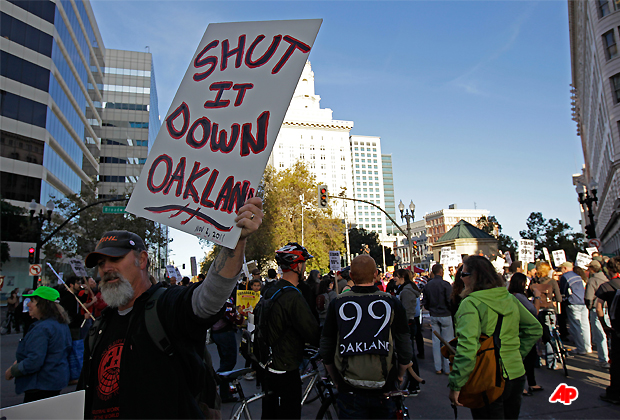 Occupy Oakland protesters close the intersection of 14th and Broadway in downtown Oakland, Calif., Wednesday, Nov. 2, 2011. Oakland's citywide general strike, a hastily planned and ambitious action called by Occupy protesters a day after police forcibly removed their City Hall encampment last week, seeks to shut down the Port of Oakland and other symbols of financial greed in their view. (AP Photo/Ben Margot)