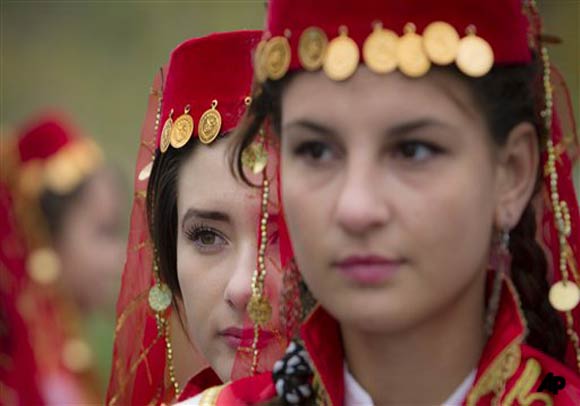 Ethnic Turkish girls from the village of Cumpana, eastern Romania, wait to perform traditional dances in Bucharest , Romania, during celebrations of Eid al Adha. The Eid al Adha, or festival of the sacrifice, commemorates the Prophet Abraham's willingness to sacrifice his son Ishmael at God's command. Romania's Turkish minority inhabits mostly the south east of the country near the Black Sea.(AP Photo/Vadim Ghirda)