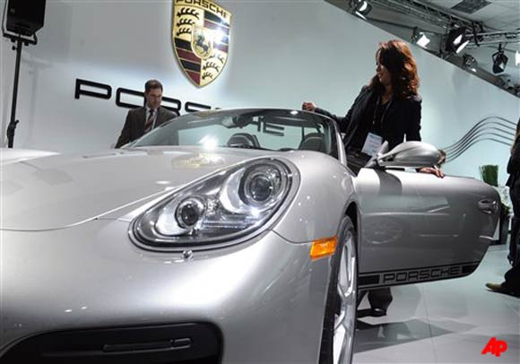 Monica Favorite, of J.D. power and Associates, climbs into a Porsche Boxster Spyder at the Los Angeles Auto Show on Wednesday, Nov. 16, 2011 in Los Angeles. (AP Photo/The Ventura County Star, Anthony Plascencia)
