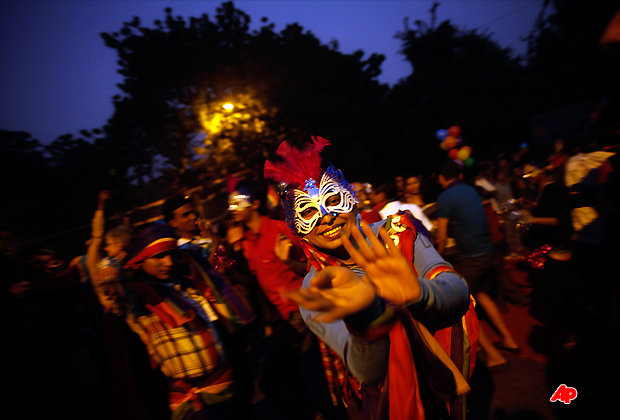 Gays, lesbians and transgenders dance into the night as they participate in the 4th Delhi Queer Pride in New Delhi, India, Sunday, Nov. 27, 2011. The parade was to protest daily harassment, violence and discrimination faced by the gay, lesbian, bisexual, inter sex and transgender community despite a Delhi High Court ruling in 2009, decriminalizing same sex behavior among consenting adults. (AP Photo/Saurabh Das)