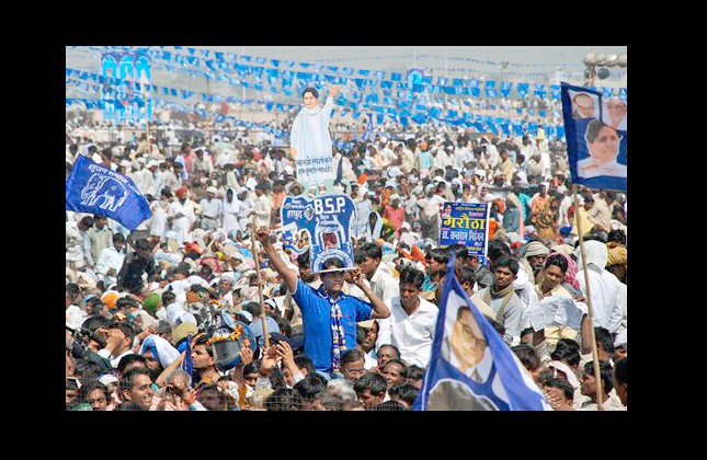 A party worker holds cut out of Uttar Pradesh state Chief Minister Mayawati, who uses just one name, on his head during Bahujan Samaj Party rally in Lucknow, India, Monday, March 15, 2010. The powerful and flamboyant leader of a party that represents India's lowest castes hosted a massive celebration in northern India on Monday to mark 25th anniversary of her political group. (Photo/Sanjay Sonkar)