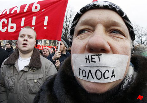 Protesters seen during a rally in downtown St.Petersburg, Russia, Saturday, Dec. 10, 2011. The sign reads No vote . More than ten thousands people have protested in St.Petersburg against Prime Minister Vladimir Putin and his party, which won the largest share of a parliamentary election that observers said was rigged. (AP Photo/Dmitry Lovetsky)