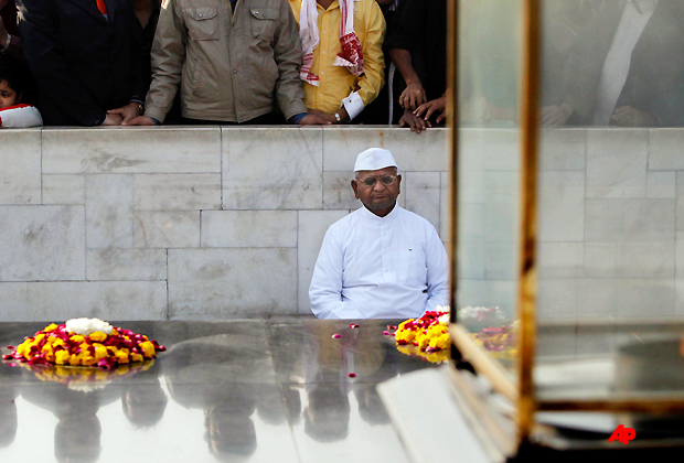 Indian anti corruption activist Anna Hazare, 74, meditates as he sits at the memorial to Mahatma Gandhi at Rajghat in New Delhi, India, Sunday, Dec. 11, 2011. Hazare began a day long token fast for a powerful anti corruption ombudsman, according to news reports. Earlier in the year Hazare went on a 12 day hunger strike pushing Parliament to consider his anti graft demands and promised his jubilant supporters that his battle against endemic corruption would continue. (AP Photo/Mustafa Quraishi)
