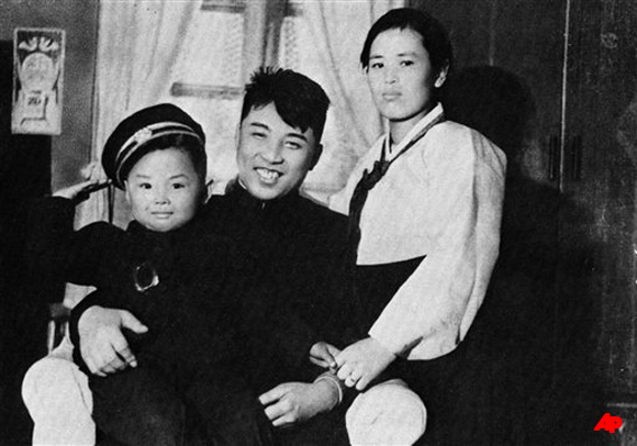 In this undated photo from North Korea's official Korean Central News Agency, distributed by Korea News Service, Kim Jong Il, left, takes part of a souvenir picture during his childhood with his parent, Kim Jong Suk, right, and leader Kim Il Sung. North Korea's news agency reported Monday, Dec. 19, 2011 that North Korean leader Kim Jong Il had died on Saturday, Dec. 17 after having a heart attack on a train. He was 69. (AP Photo/Korean Central News Agency via Korea News Service)