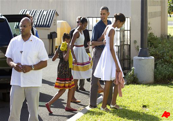 President Barack Obama, first lady Michelle Obama, and their daughters Malia and Sasha arrive for Christmas service at the Kaneohe bay Chapel on Marine Corps Base Hawaii, Sunday, Dec. 25, 2011, in Kaneohe, Hawaii. (AP Photo/Carolyn Kaster)