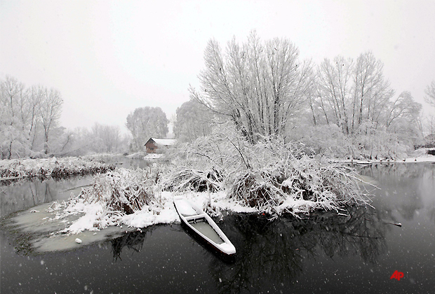 A boat stands covered in snow on the outskirts of Srinagar, India, Saturday, Jan. 7, 2012. The Jammu Srinagar highway has been blocked because of heavy snowfall in the region, according to news reports. (AP Photo/Dar Yasin)