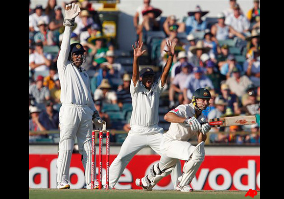 India's MS Dhoni, left, and Rahul Dravid, center, appeal for a wicket against Australia's Ed Cowen, right, during their cricket test match at the WACA in Perth, Australia, Friday, Jan. 13, 2012. India's were all out for 161 in their first innings. (AP Photo/Theron Kirkman)