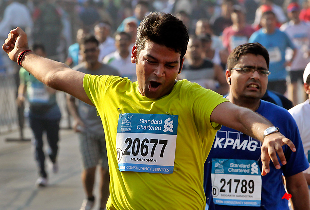 An Indian participant celebrates after he completes the Standard Chartered Mumbai Marathon in Mumbai, India, Sunday, Jan. 15, 2012. (AP Photo/Rajanish Kakade)