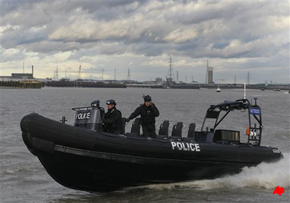 A police inflatable rib performs during a combined Police and Royal Marines security exercise on the River Thames in London, Thursday, Jan. 19, 2012. The security exercise was performed in preparation for the London 2012 Olympic games. (AP Photo/Kirsty Wigglesworth)