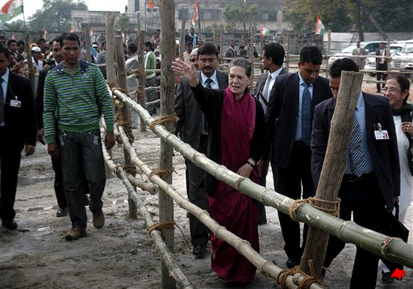 Congress party President Sonia Gandhi, center, waves to supporters during an election campaign rally in Unnao, about 60 kilometers (37 miles) west of Lucknow, India, Wednesday, Feb. 8, 2012. Residents in India's largest state began voting Wednesday in a month long local election with repercussions for the whole nation. A poor Congress showing could leave the national government crippled for the last two years of its term. (AP Photo/Nirala Tripathi)