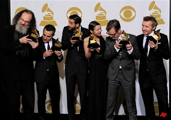 From left, Andrew Scheps, Gary Fidelman, Philip Allen, Beatriz Artola, Dan Wilson and Fraser T. Smith pose with their awards for album of the year for 21 backstage at the 54th annual Grammy Awards on Sunday, Feb. 12, 2012 in Los Angeles. (AP Photo/Mark J. Terrill)