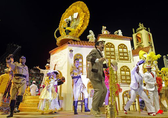 Dancers from the Mocidade Alegre samba school perform on a float during a carnival parade in Sao Paulo, Brazil, early Sunday Feb. 19, 2012. Carnival runs Feb. 17 21. (AP Photo/Andre Penner)