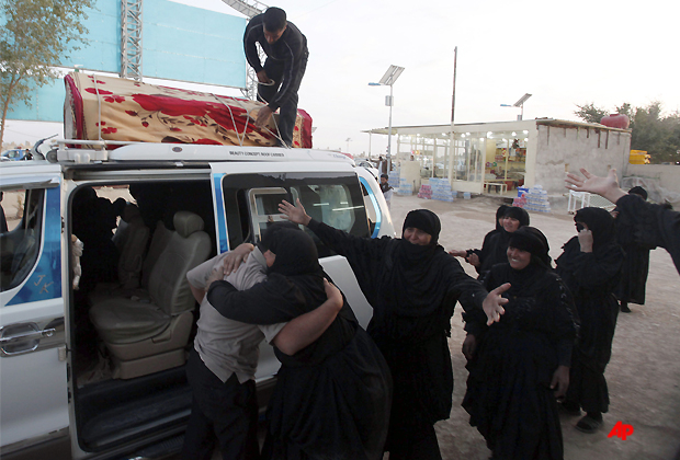 Family members of Tamara Ammar, 12, who was killed in a car bomb react before his burial in Najaf, 100 miles (160 kilometers) south of Baghdad, Iraq, Tuesday, March 20, 2012. Officials say attacks across Iraq have killed and wounded scores of people, police said, in a spate of violence that was dreaded in the days before Baghdad hosts the Arab world's top leaders. (AP Photo/Alaa al Marjani)