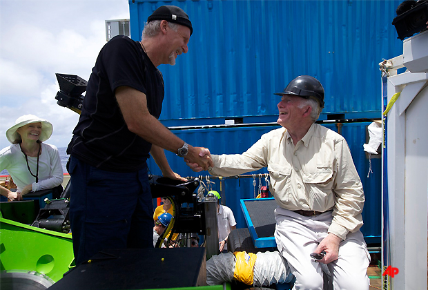 Filmmaker and National Geographic Explorer in Residence James Cameron is congratulated by ocean explorer and U.S. Navy Capt. Don Walsh, right, after completing the first ever solo dive to the Challenger Deep, the lowest part of the Mariana Trench. Walsh took the same journey to the bottom of the Mariana Trench 52 years ago in the bathyscaphe Trieste with Swiss oceanographer Jacques Piccard. Cameron's dive in his specially designed submersible was part of Deepsea Challenge, a joint scientific expedition by Cameron, the National Geographic Society and Rolex to conduct deep ocean research. (AP Photo/Mark Theissen, National Geographic)