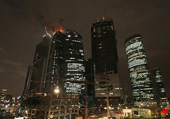 Smoke and flame rises from the top of the Federation tower of the Moscow City business compound in downtown Moscow, Monday, April 2, 2012. (AP Photo/Sergey Ponomarev)