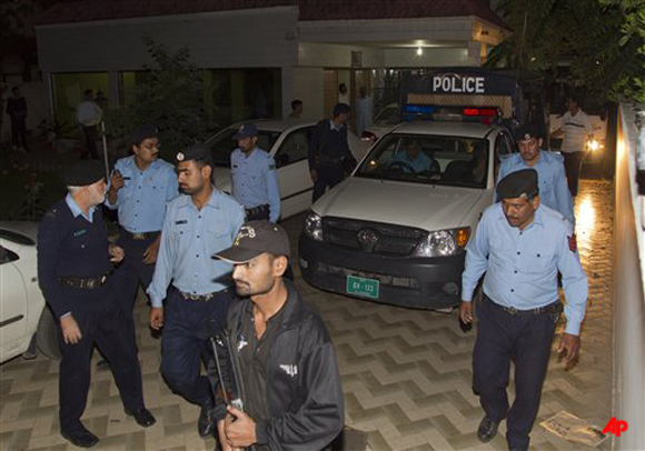 Police officers escort a vehicle carrying the family of Osama bin Laden, in Islamabad, Pakistan on Thursday, April 26, 2012. A van carrying the three widows and children of Bin Laden has left the house where they have been staying in Islamabad and is en route to the airport, from where they will be deported to Saudi Arabia, officials and witness said. (AP Photo/B.K. Bangash)