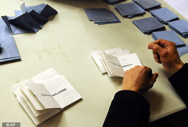 An election worker counts ballots during the second round of the French presidential elections, in Paris, Sunday, April 22, 2012. Socialist Francois Hollande defeated Sarkozy on Sunday to become France's next president, Sarkozy conceded defeat minutes after the polls closed. (AP Photo/Zacharie Scheurer)