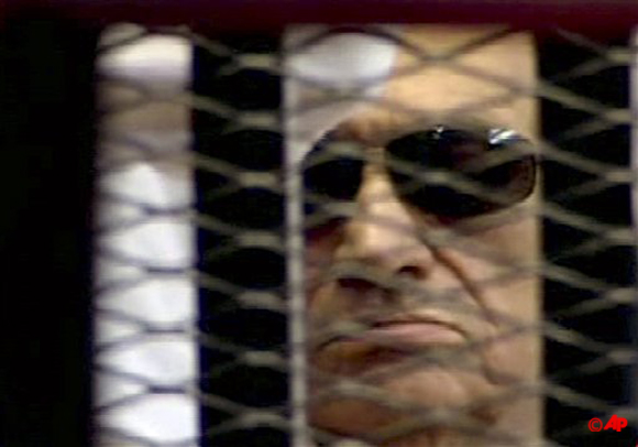 In this video image taken from Egyptian State Television, 84 year old former Egyptian president Hosni Mubarak is seen in the defendant's cage as a judge reads the verdict in on charges of complicity in the killing of protesters during last year's uprising that forced him from power, in Cairo, Egypt, Saturday, June 2, 2012. Egypt's ex President Hosni Mubarak has been sentenced to life in prison after a court convicted him on charges of complicity in the killing of protesters during last year's uprising that forced him from power. (AP Photo/Egyptian State TV)