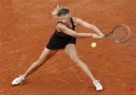 Russias Maria Sharapova returns the ball to Estonia's Kaia Kanepi during their quarterfinal match in the French Open tennis tournament at the Roland Garros stadium in Paris, Wednesday, June 6, 2012. (AP Photo/Christophe Ena)