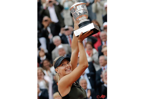 Maria Sharapova of Russia holds the trophy after winning the women's final match against Sara Errani of Italy at the French Open tennis tournament in Roland Garros stadium in Paris, Saturday June 9, 2012. Sharapova won in two sets 6 3, 6 2. (AP Photo/Michel Euler)