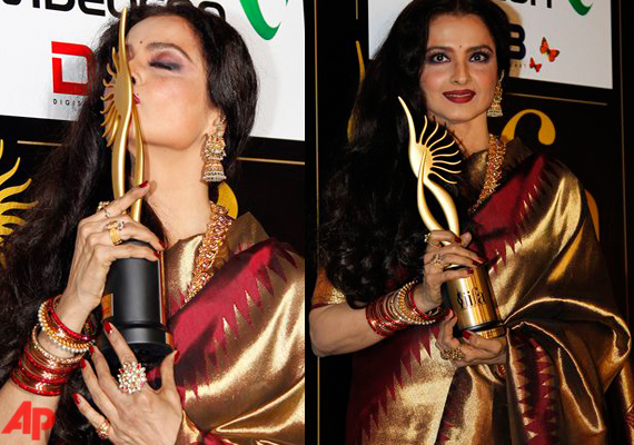 Winner of the of the Life Achievement Award, Bollywood actress Rekha kisses her award at the Jaypee International Indian Film Academy (IIFA) awards held on Saturday, June 9, 2012 in Singapore.