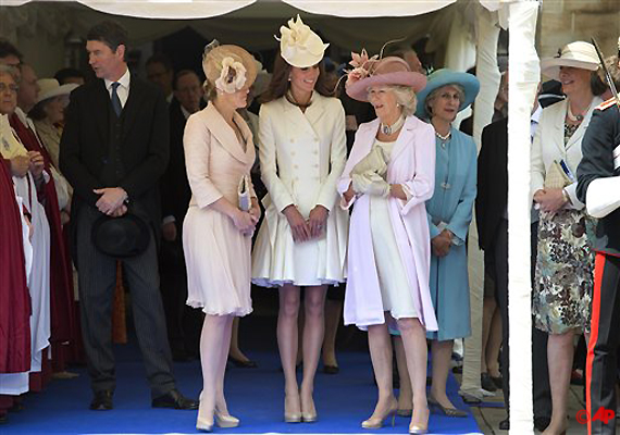 Sophie, Countess of Wessex, Kate, the Duchess of Cambridge, center, and Camilla, Duchess of Cornwall, right, chat as they watch their husband's pass by wearing lavish blue velvet robes and black velvet hats with white plumes, during the procession of The Most Noble Order of the Garter in the grounds of Windsor Castle, Windsor, England Monday June 18, 2012. The Most Noble Order of the Garter, founded in 1348, is the highest order of chivalry existing in England. Recipients of the honor are chosen because they have held public office, contributed to national life or served the sovereign personally. The appointment of Knights of the Garter is in the Queen's gift and is made without consulting ministers. (AP Photo/Paul Edwards, Pool)